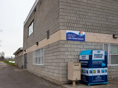 Outside the Little Britain branch - large grey brick community centre 